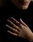 A closeup of a hand with two rings. The first ring is the messenger ring with natural purple chalcedony gemstone and the second ring is the soul ring with natural amethyst gemstone. All jewelry are made of silver and gold vermeil. Demi-fine jewelry. Made in Athens, Greece, Europe,EU.